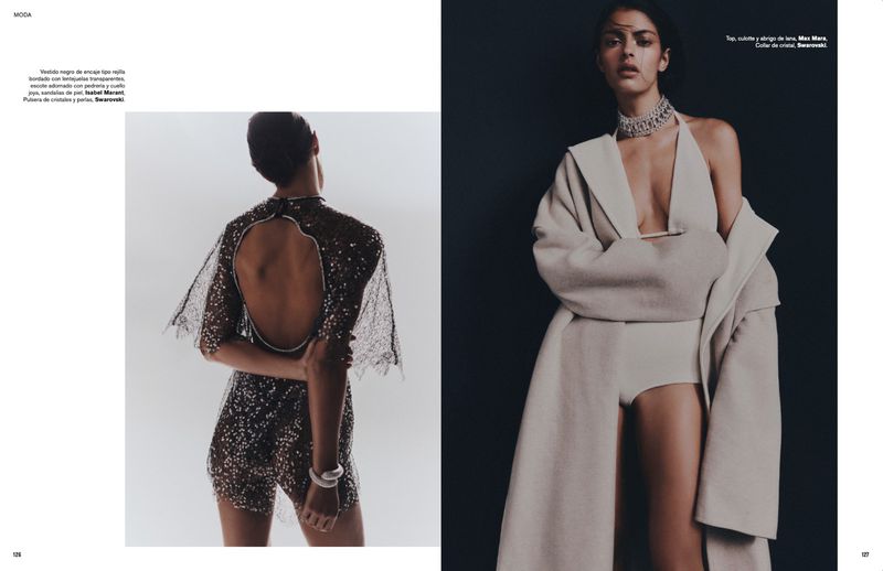 Two fashion models pose in a studio setting, one in a sequined romper, the other in a coat with a cream-colored bodysuit.