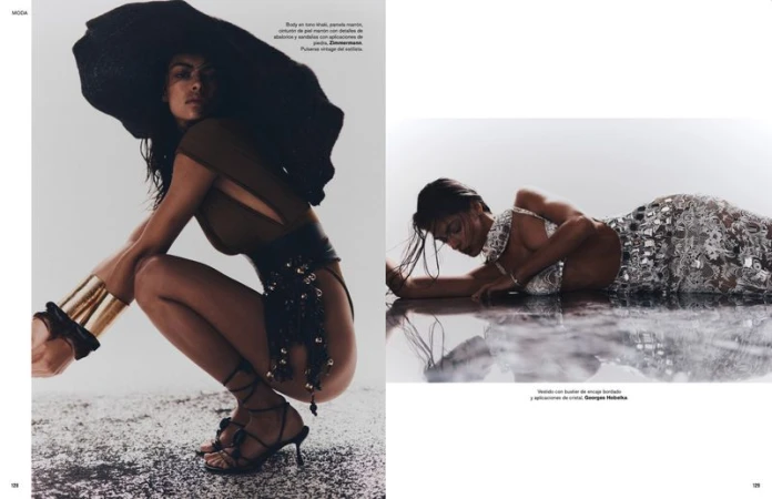 Fashion editorial shot of a woman in a hat squatting, and a model lying in a dress, in a studio with a reflective floor.
