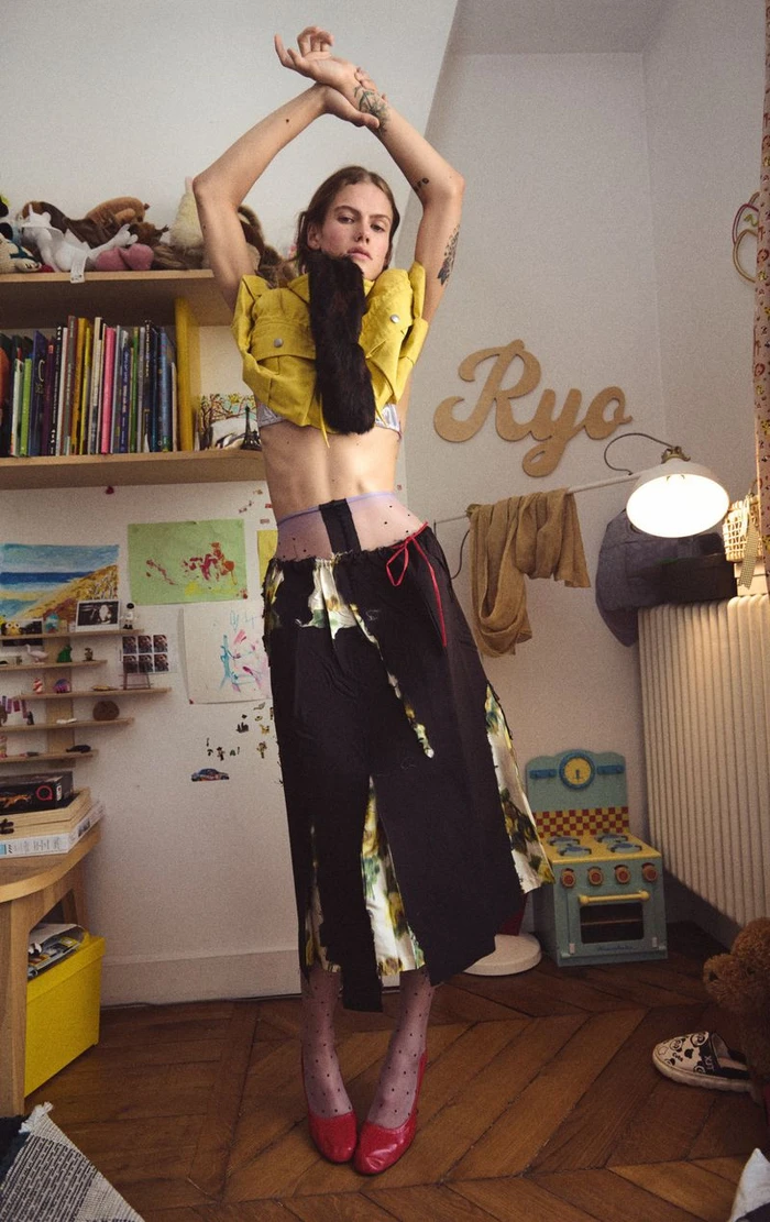 Model Lucia Richardson posing with arms raised in a children bedroom interior for Household by Oliver Hadlee Pearch