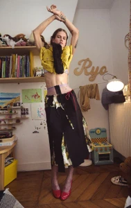 Model Lucia Richardson posing with arms raised in a children bedroom interior for Household by Oliver Hadlee Pearch