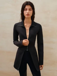 Model Victoria Blecher wearing a black zip jacket against a textured neutral background for Beyond Noise