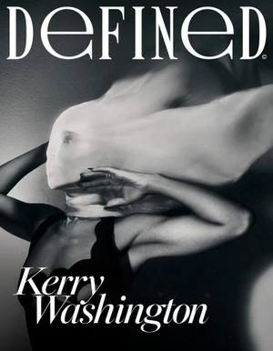 Monochrome portrait of Kerry Washington with a semi-sheer fabric draped over her head, wearing a dark top.