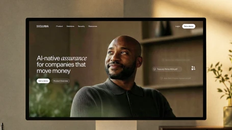A computer monitor displaying the Clusia website homepage with a portrait of a black man and typography.