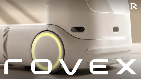 Close-up shot of a white robotic device with a glowing yellow wheel and embedded camera lenses, created by Rovex.