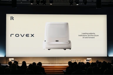 Rovex brand presentation on a large screen before an audience in a dark auditorium