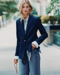 Model Grace Elizabeth in a navy blazer, striped shirt, and jeans outdoors for Veronica Beard Fall 2026 campaign.