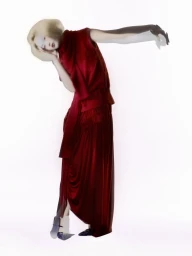 Model Xie Chaoyu wearing a red dress in a motion-blurred pose against a white background for Numero Netherlands