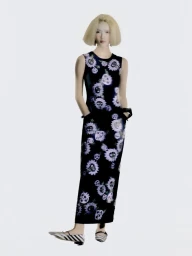 Model Xie Chaoyu wearing a sleeveless black floral dress with patterned flats against a plain white studio backdrop.