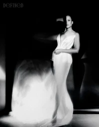 Monochrome portrait of Kerry Washington in a structured white dress against a dark background for DEFINED Magazine