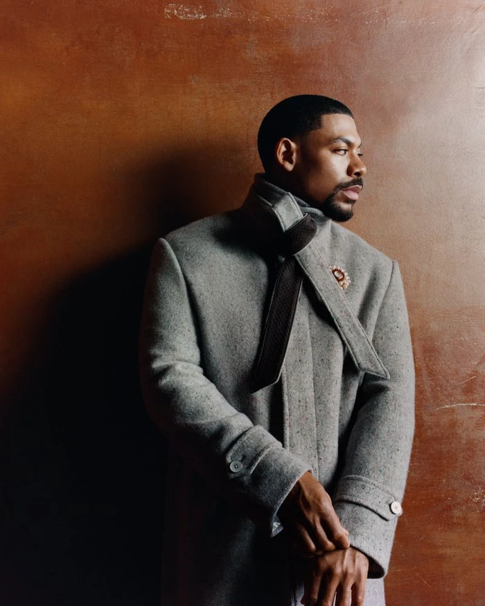 Portrait of actor Aaron Pierre wearing a grey wool coat with a dark scarf for Esquire UK, photographed by Olivia Lifungula.