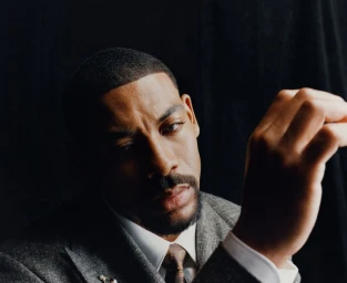 Portrait of actor Aaron Pierre wearing a grey suit for Esquire UK photographed by Olivia Lifungula