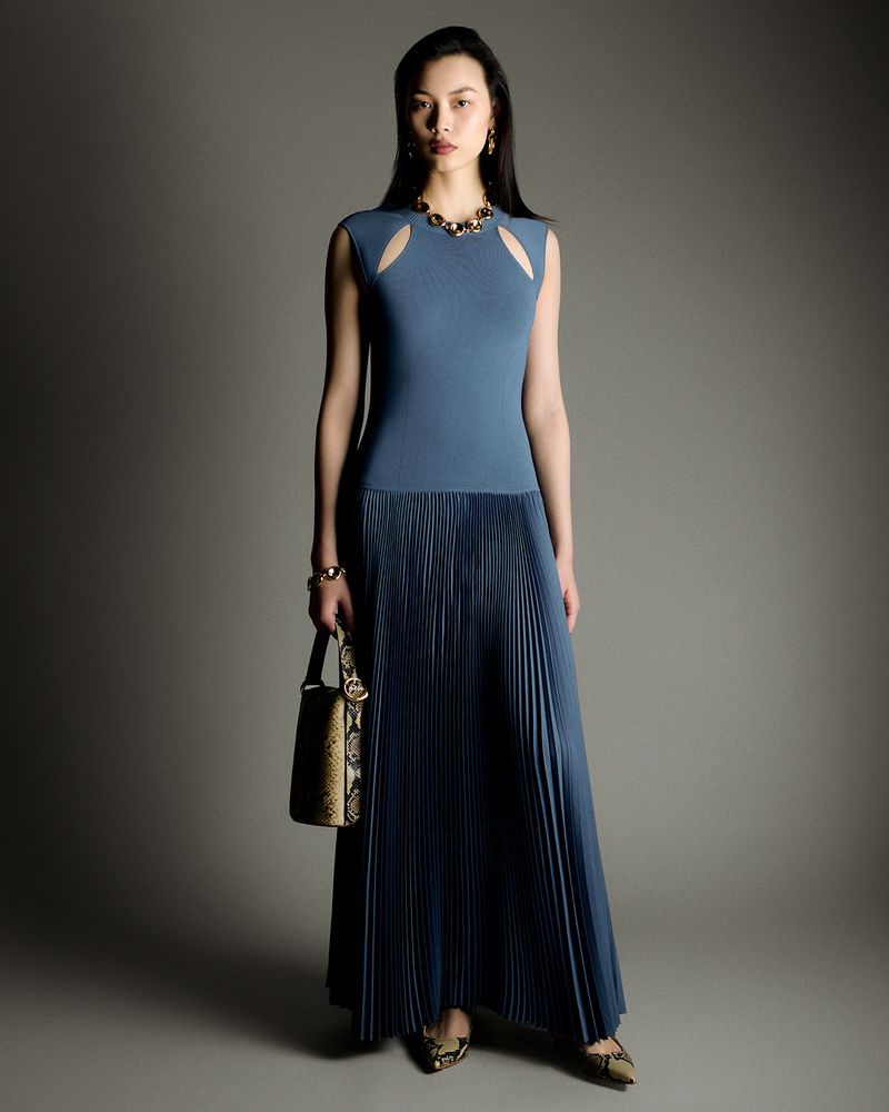 Model Bingbing Liu wearing a blue pleated dress holding a handbag in Joseph A/W 26 lookbook