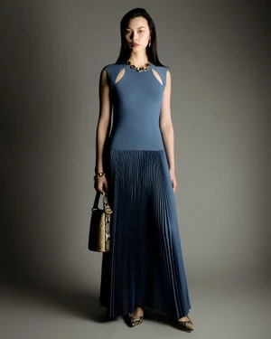 Model Bingbing Liu wearing a blue pleated dress holding a handbag in Joseph A/W 26 lookbook