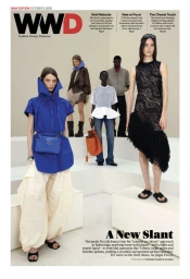 Five models on white tiered platforms showcasing modern designer apparel including a blue tunic and patterned dress