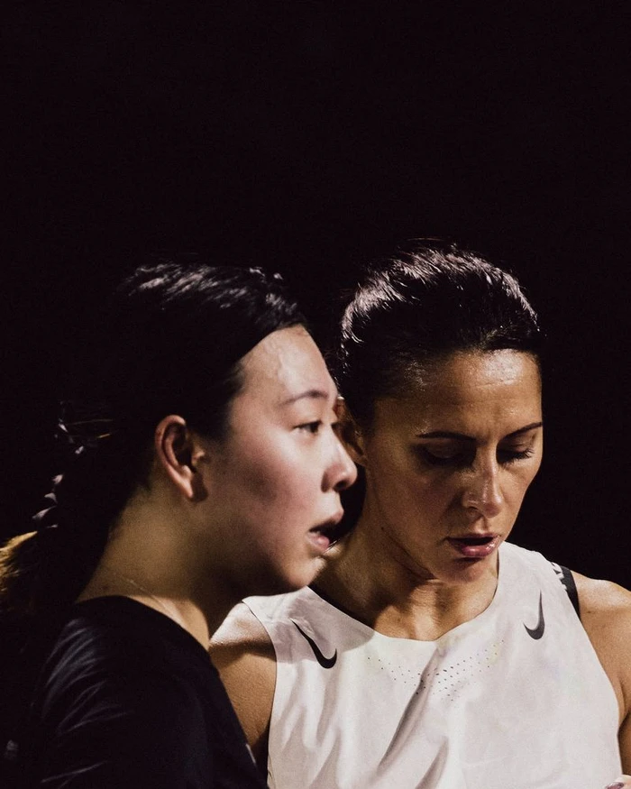 Two women in athletic wear against a dark background for Nike After Dark by photographer Carina Lammers.