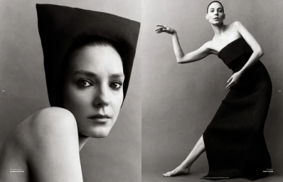 Model Kati Nescher in a black strapless dress and sculptural hat against a grey seamless background