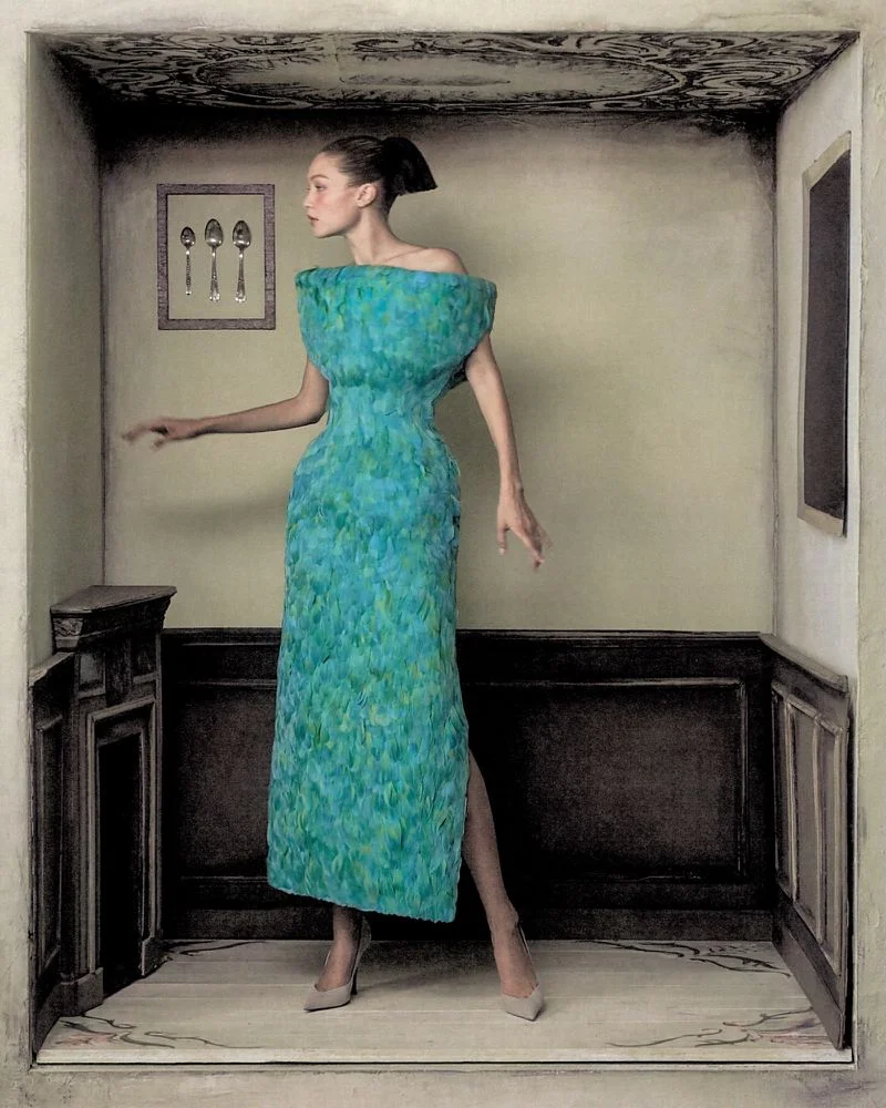 Gigi Hadid wearing a textured turquoise dress standing inside a miniature room set for WSJ Queen of Couture editorial.