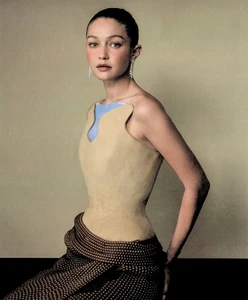Gigi Hadid in a structured beige top and polka dot skirt for WSJ editorial