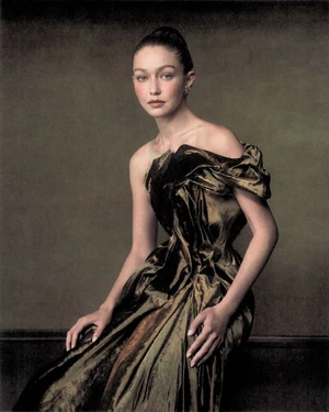 Gigi Hadid wearing a sculptural bronze velvet gown in a painterly portrait for WSJ Magazine shot by Szilveszter Mako.