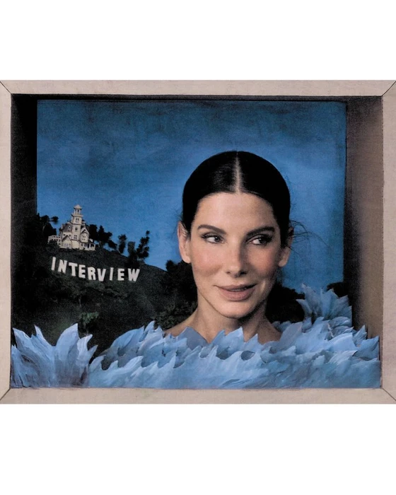 Portrait of Sandra Bullock in a diorama set featuring a miniature house and the word Interview on a hillside
