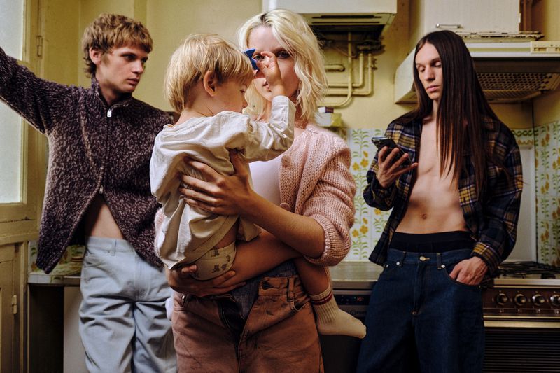 Four adults and a young child in a kitchen, photographed for Hube Magazine by Francesco Bonasia.