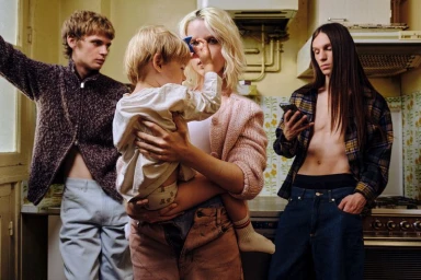 Four adults and a young child in a kitchen, photographed for Hube Magazine by Francesco Bonasia.