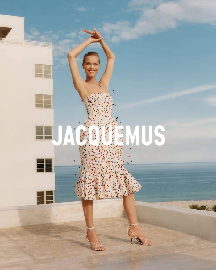 Eva Herzigova in a strapless polka-dot dress standing on a rooftop overlooking the sea for Jacquemus