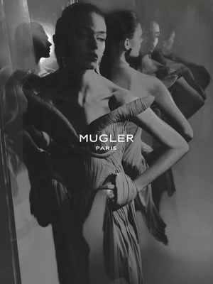 Monochrome fashion campaign image featuring models in structured gowns reflected against mirrored surfaces for Mugler