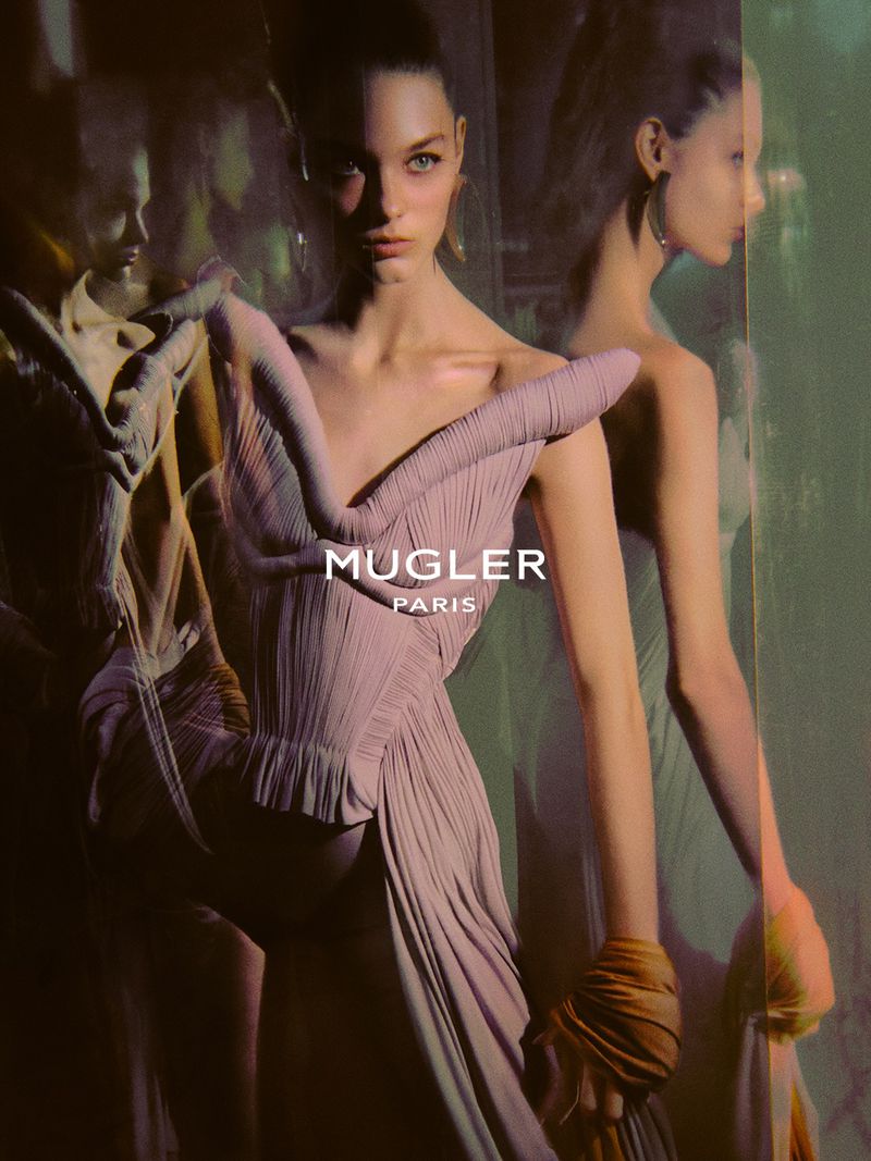 Model in pleated pink dress with Mugler Paris logo for Naturalia X Spring Summer 2027 campaign shot by Elizaveta Porodina.