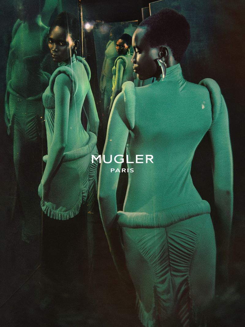 Model in green structured garment posing before mirrors for Mugler Naturalia Spring Summer 2027 campaign.