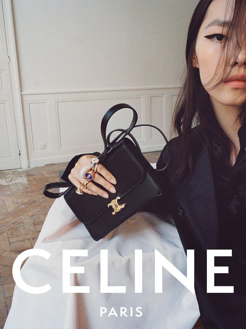 Model holding a black leather handbag with gold clasp for Celine Spring 2027