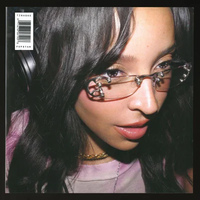 Tinashe wearing frameless metal glasses and headphones for an album cover portrait by Hugo Comte.