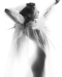 Model in sheer white ruffled top posing against a bright white background for Chloé Summer '27