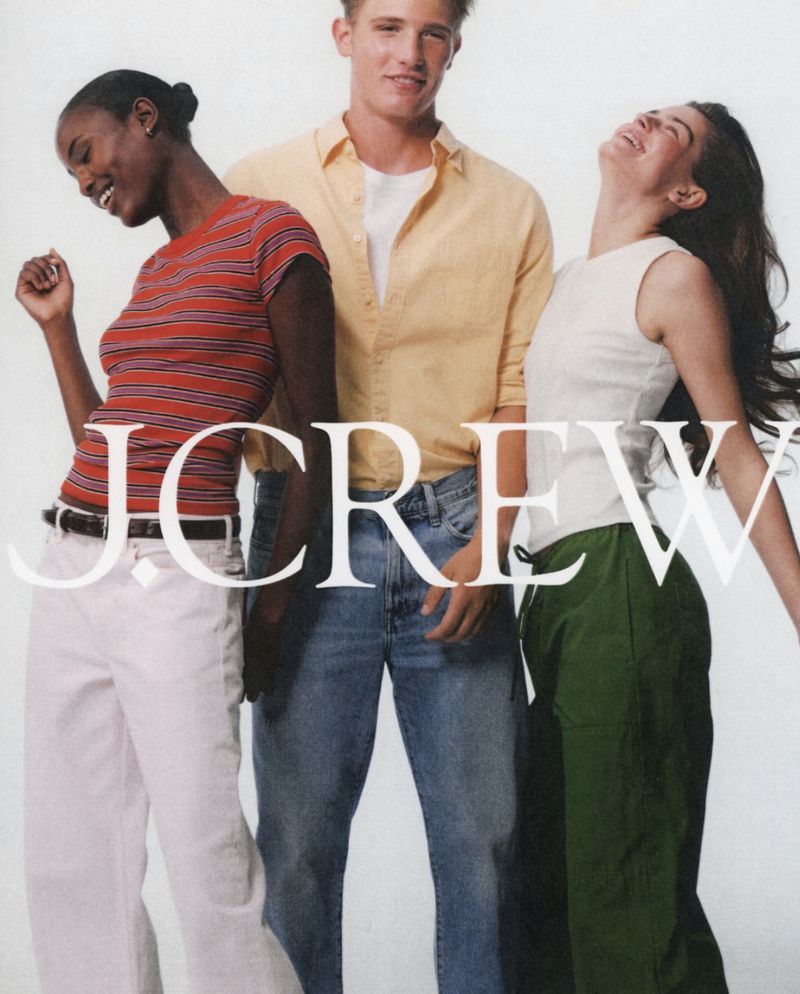 Three models laughing and posing against a plain white background for J. Crew photographed by Dudi Hasson.