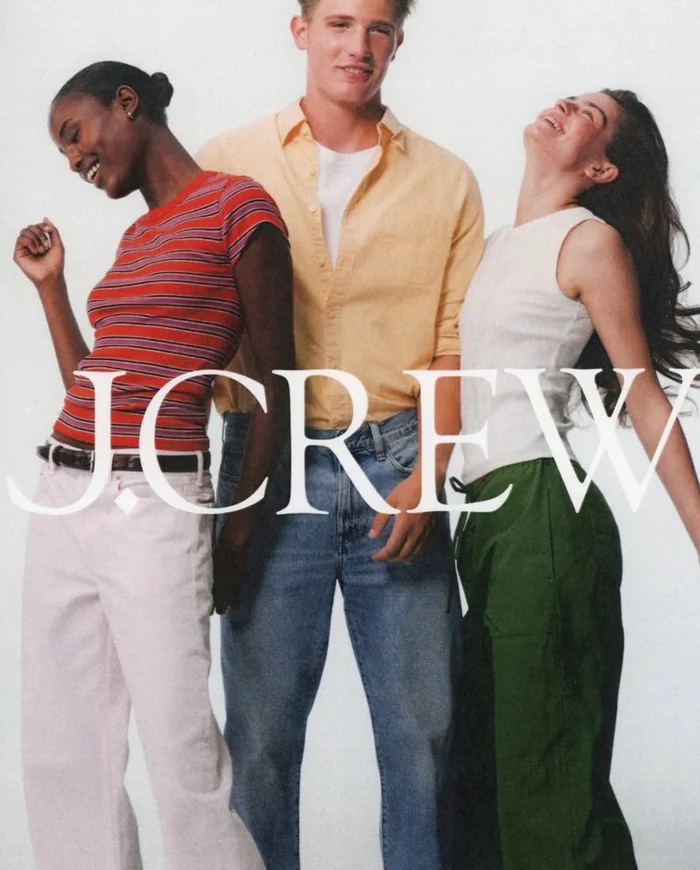 Three models laughing and posing against a plain white background for J. Crew photographed by Dudi Hasson.