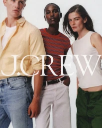 Three models posing for J.Crew wearing casual shirts, striped t-shirt, and white pants against a white seamless background