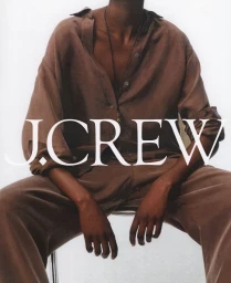 Person wearing a brown button-down shirt and matching trousers against a plain light background with J. Crew overlay text