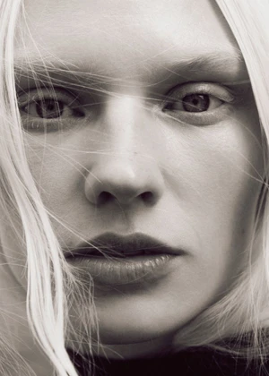 Close-up portrait of a woman with long blonde hair blowing across her face for Elle Sweden
