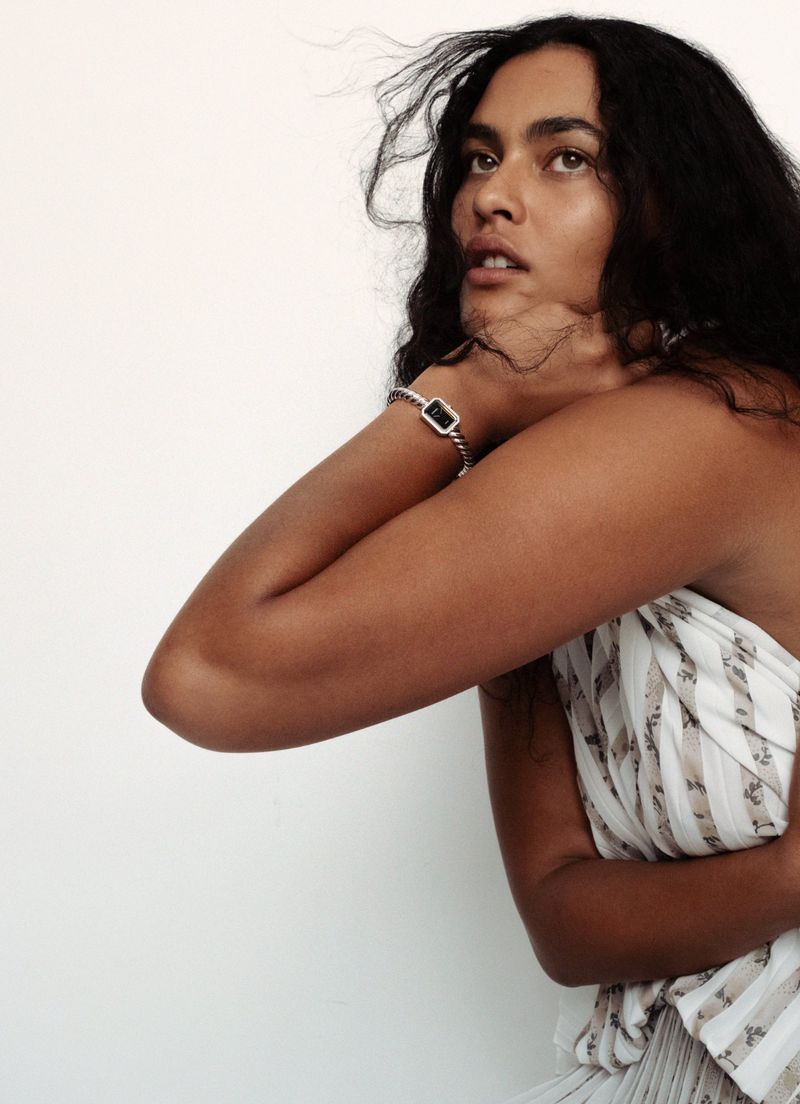 Model Ylang Messenguiral wearing a patterned white dress with a bracelet for M Le magazine du Monde