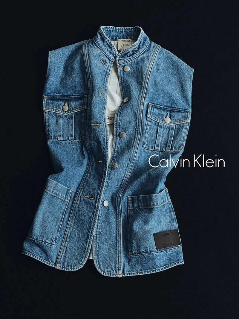 Blue denim vest with front pockets layered over a white t-shirt against a dark background