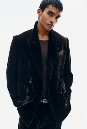 Model in a dark brown velvet blazer against a plain white background for H&M Diwali Collection