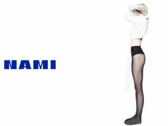 Model Dree Hemingway in white crop top and sheer black tights standing against a bright white background for Nami