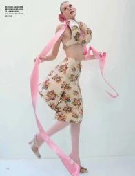 Model in floral two-piece set with long pink ribbons against a seamless white background for Vogue China.