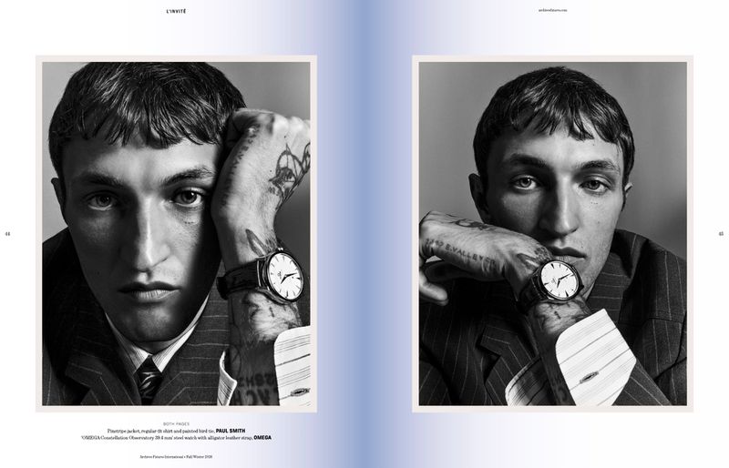 Anwar Hadid wearing a pinstripe jacket and wristwatch in a black and white editorial portrait by Harry Eelman.