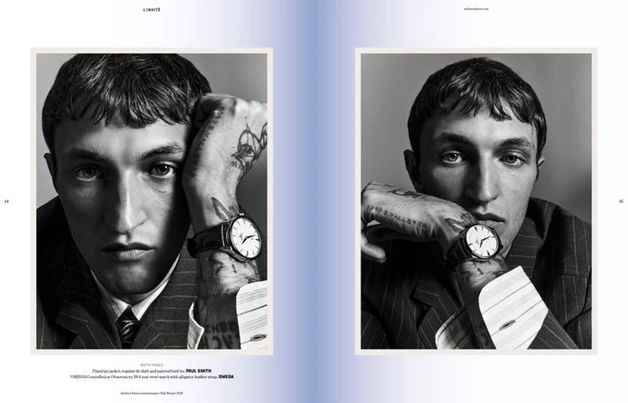 Anwar Hadid wearing a pinstripe jacket and wristwatch in a black and white editorial portrait by Harry Eelman.