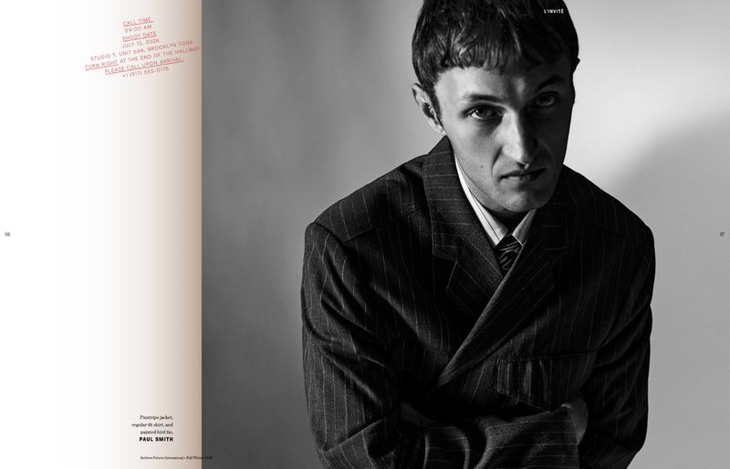 Anwar Hadid in a pinstripe jacket and collared shirt against a plain studio background for Archives Futures.
