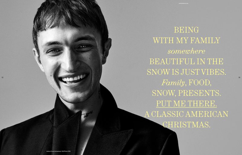 Anwar Hadid smiling in a black jacket against a grey background with yellow quote text for Archives Futures editorial photography.