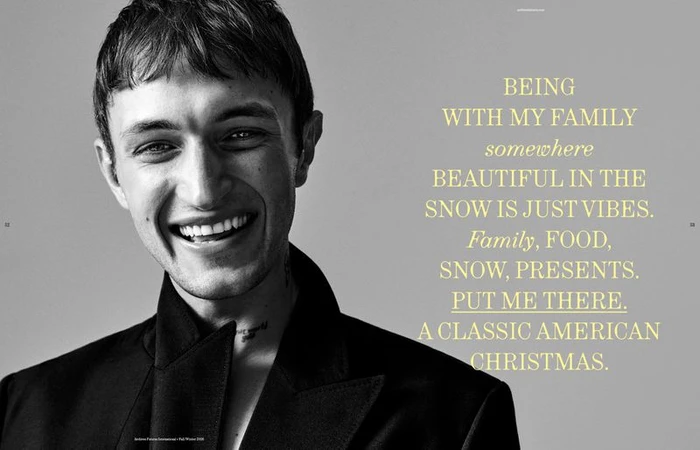 Anwar Hadid smiling in a black jacket against a grey background with yellow quote text for Archives Futures editorial photography.