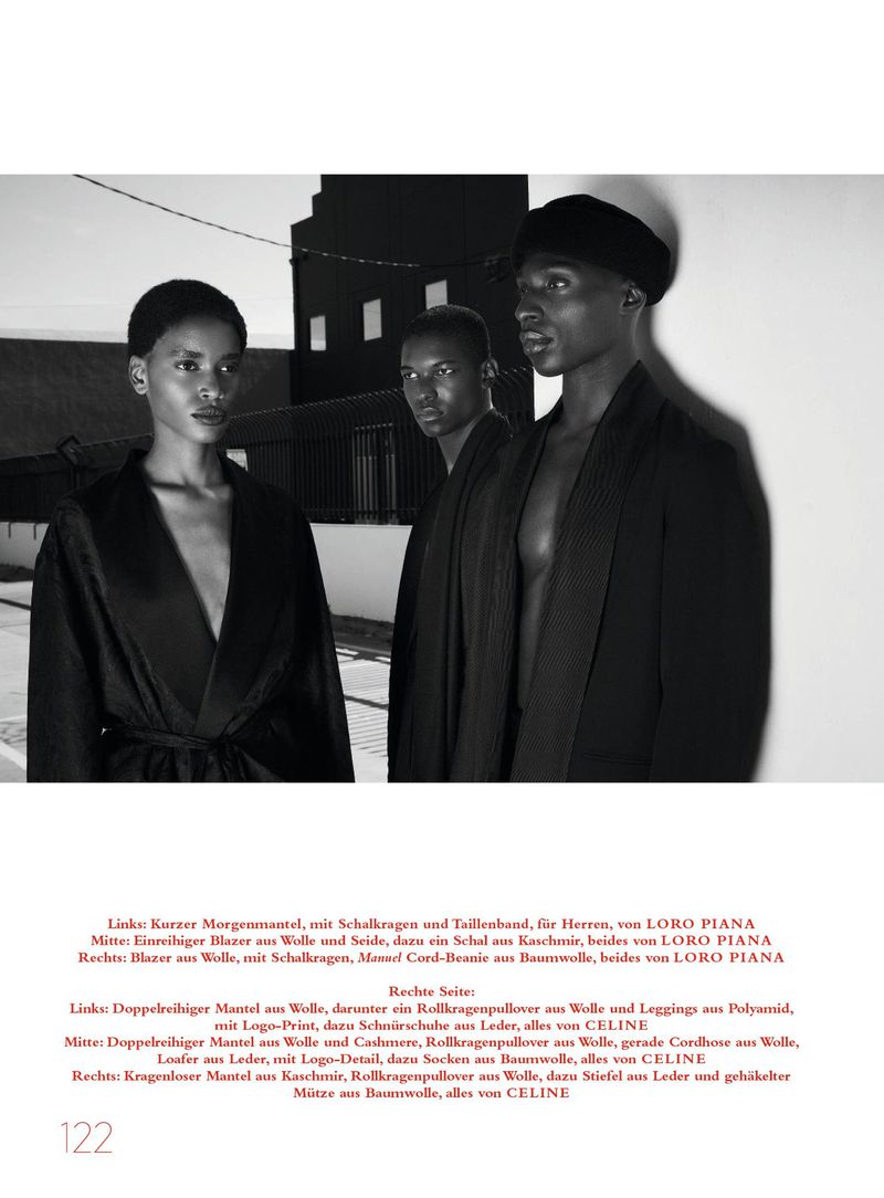 Three models wearing dark tailored garments posed outdoors against an architectural background in black and white.