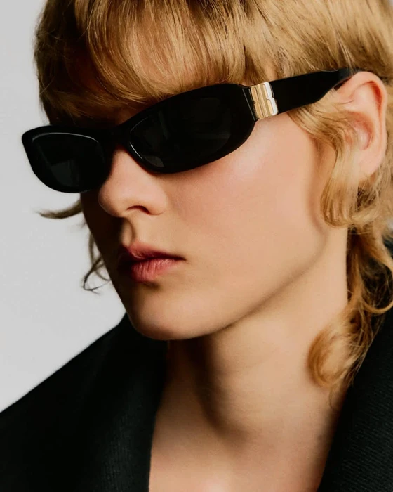 Close-up portrait of a model wearing black sunglasses against a white background for the Balenciaga Fall 2026 eyewear campaign